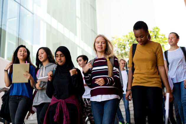 Diverse group of students walking in school