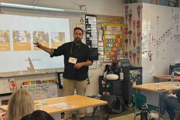Doug Keller presenting to a classroom of seated students.