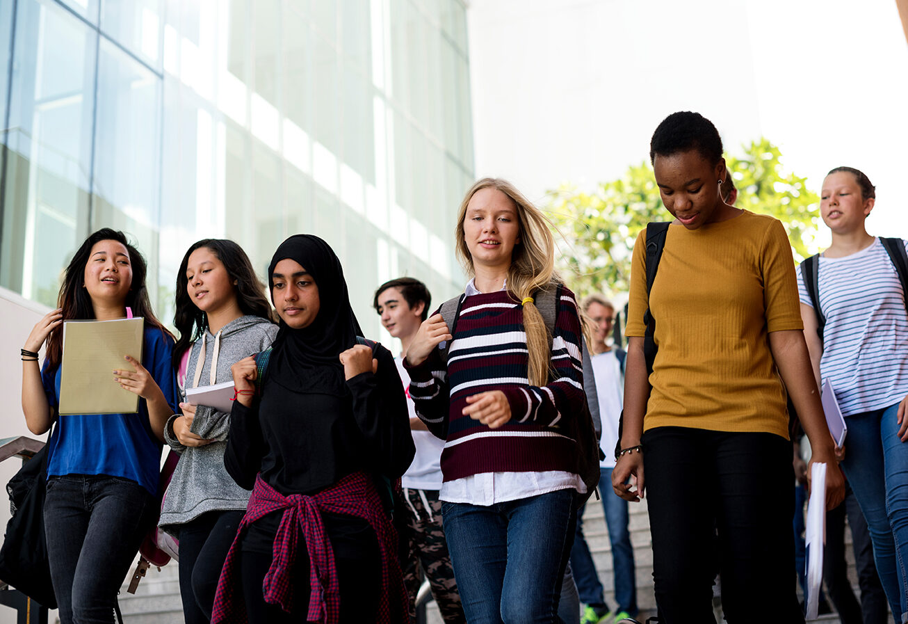 Diverse group of students walking in school